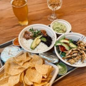 Grapevine Restuarants Harvest Hall: tostadas, guacamole, whit rice in a bowl, chicken and avacados in a bowl with a glass of beer and wine